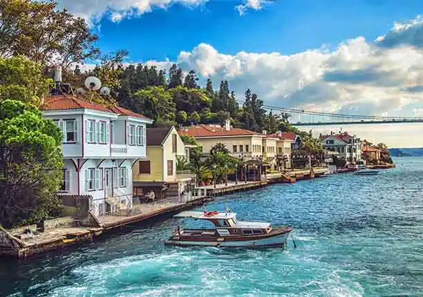 a vibrant photograph of the bosphorus with a seaside mansion