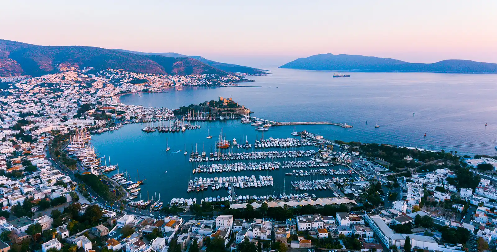 Bodrum is a great place to visit and live in. A beautiful landscape of Bodrum during sunset with sea and green spaces.